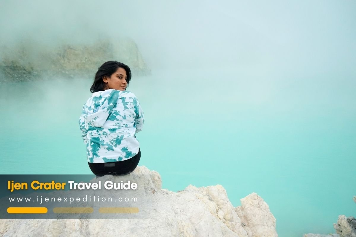 Hikers trekking uphill on the Ijen Crater trail at night with headlamps