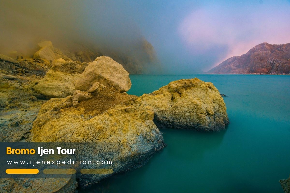 Ijen Crater turquoise lake with sulfur fumes at sunrise, East Java