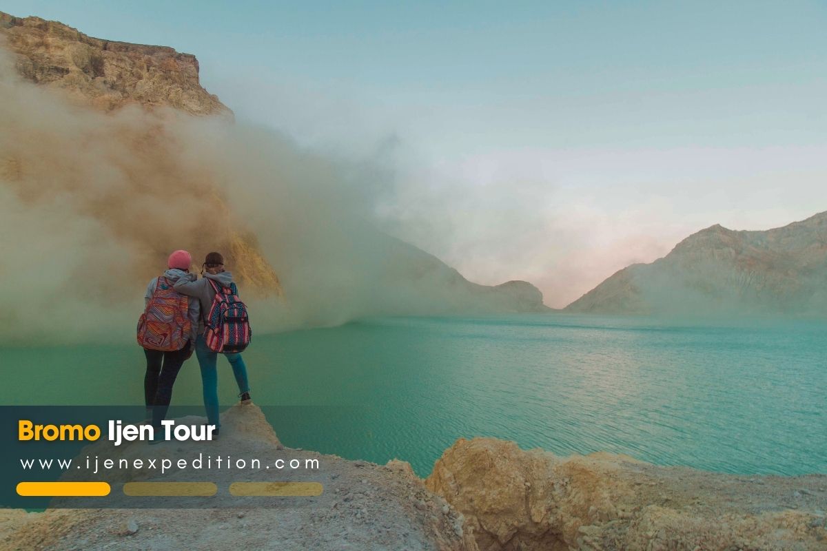 International travelers with local guide enjoying Ijen Crater view, East Java