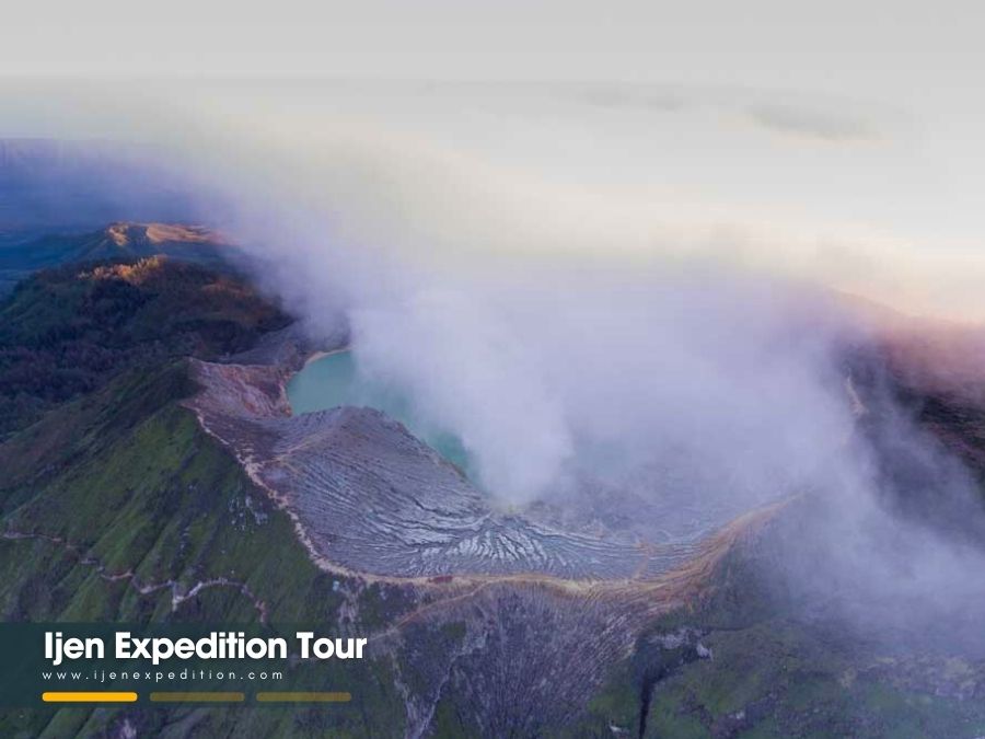 Sunrise over turquoise lake at Ijen Crater