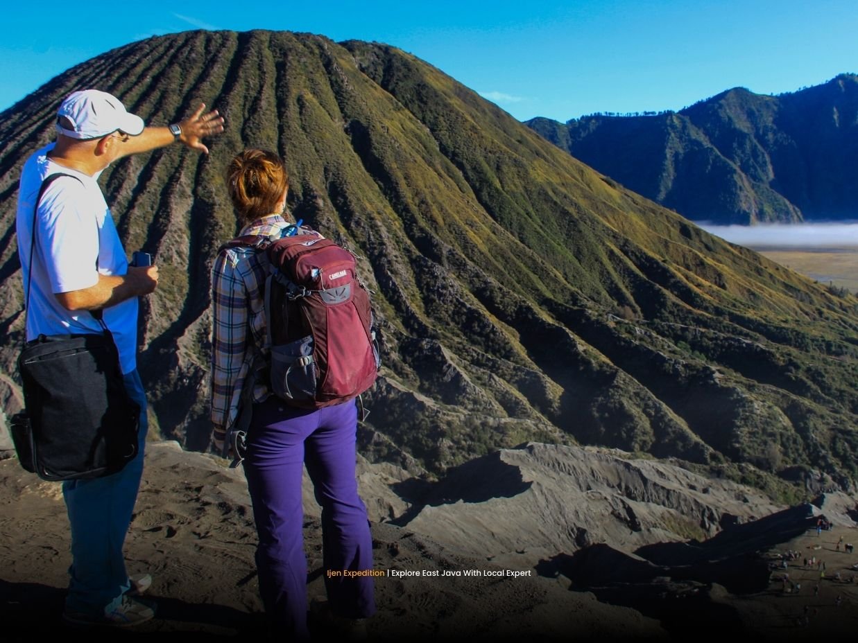 Visitors walking across the Sea of Sand toward Mount Bromo crater