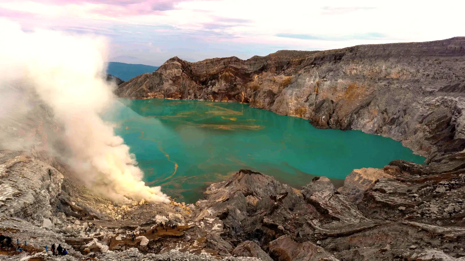The Hardworking Sulfur Miners of Ijen Miners carrying heavy baskets of sulfur at Ijen Crater