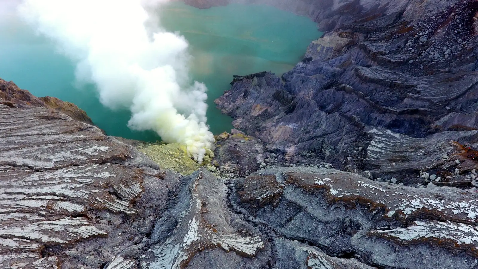 Ijen Acid Lake at Dawn The turquoise acidic lake of Ijen Crater surrounded by volcanic walls